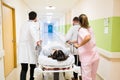 Medical Professionals Rushing Woman On Gurney In Hospital Royalty Free Stock Photo