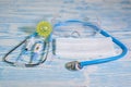 Medical protective masks and stethoscope on a blue wooden surface. Cavid-19 coronavirus infections