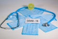 Medical protective masks and stethoscope on a blue wooden surface. Cavid-19 coronavirus infections