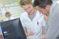 Medical receptionist conversing with man Royalty Free Stock Photo