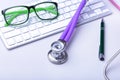 Medical record concept with stethoscope over pile of folders. Keyboard, glasses, pen, RX prescription. Selective focus Royalty Free Stock Photo