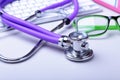 Medical record concept with stethoscope over pile of folders. Keyboard, glasses, pen, RX prescription. Selective focus Royalty Free Stock Photo