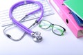 Medical record concept with stethoscope over pile of folders. Keyboard, glasses, pen, RX prescription. Selective focus Royalty Free Stock Photo