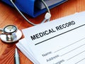 Medical record and stack of papers with stethoscope Royalty Free Stock Photo