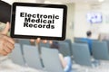 Medical record system show on tablet in someone hand on blur hospital background. Royalty Free Stock Photo