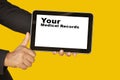Medical record system show on tablet in someone hand on yellow background. Royalty Free Stock Photo
