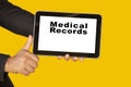 Medical record system show on tablet in someone hand on yellow background. Royalty Free Stock Photo