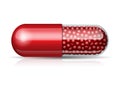 Medical red capsule with granules Royalty Free Stock Photo
