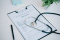 Medical report, stethoscope and pen near flowerpot Royalty Free Stock Photo