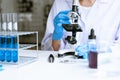 Medical Research asian Scientist Working With Microscope Doing Research Making Scientific Experiment, Works in a Bright Modern Royalty Free Stock Photo