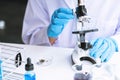 Medical Research asian Scientist Working With Microscope Doing Research Making Scientific Experiment, Works in a Bright Modern Royalty Free Stock Photo