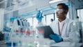 Medical Research Laboratory: Portrait of a Handsome Male Scientist Using Digital Tablet Computer, Royalty Free Stock Photo