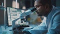 Medical Research Scientist Conducts DNA Experiments Under a Digital Microscope in a Biological App Royalty Free Stock Photo