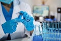 Medical or research scientist or doctor using looking at a test tube of clear solution in a lab or laboratory Royalty Free Stock Photo