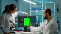 Medical research scientists using notepad with green screen