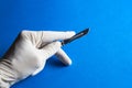 Medical scalpel in a hand with rubber glove Royalty Free Stock Photo