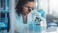 Medical Science Laboratory: Portrait of Beautiful Black Scientist Looking Under Microscope Does Royalty Free Stock Photo