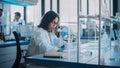 Medical Science Laboratory: Portrait of Beautiful Black Scientist is Using Microscope Does Analysis Royalty Free Stock Photo