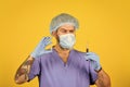 medical scientist hold test tubes. doctor wearing surgical mask while testing. nurse examines blood samples in lab. what