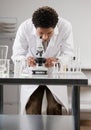 Medical scientist looking through microscope