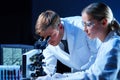 Medical scientists working in lab. Doctor teaching interns to make blood analyzing research. Coronavirus, biotechnology Royalty Free Stock Photo