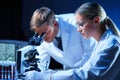 Medical scientists working in lab. Doctor teaching interns to make blood analyzing research. Coronavirus, biotechnology Royalty Free Stock Photo