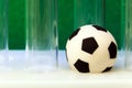 Medical scratched test tubes and a souvenir soccer ball on a green background. Concept money and sports, medicine and football, co Royalty Free Stock Photo