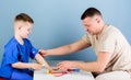 Medical service. Man doctor sit table medical tools examining little boy patient. Health care. Pediatrician concept Royalty Free Stock Photo