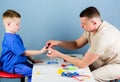 Medical service. Man doctor sit table medical tools examining little boy patient. Pediatrician concept. Health care Royalty Free Stock Photo