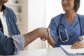 Medical Services. Doctor Woman And Male Patient Handshaking During Meeting In Clinic Royalty Free Stock Photo