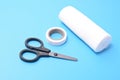 Medical set: a plaster, bandage scissors, isolated on a blue background. Royalty Free Stock Photo