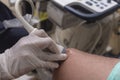 A medical sonographer using a transducer to conduct a knee ultrasound of a male patient at a clinic Royalty Free Stock Photo