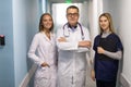 Medical staff discussing in clinic hallway. Healthcare professionals having discussion in hospital corridor Royalty Free Stock Photo