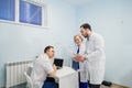 Medical staff discussing over medical reports using laptop and tablet pc. Healthcare professionals having discussion in Royalty Free Stock Photo