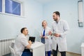 Medical staff discussing over medical reports using laptop and tablet pc. Healthcare professionals having discussion in Royalty Free Stock Photo