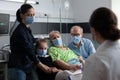 Medical staff member reviewing elderly bedridden woman files