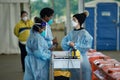 Medical staff in personal protective equipment and infection control at covid-19 vaccination clinic