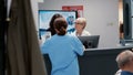 Medical staff and secretary talking at hospital reception desk Royalty Free Stock Photo