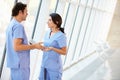 Medical Staff Talking In Hospital Corridor With Digital Tablet Royalty Free Stock Photo