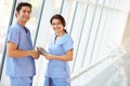 Medical Staff Talking In Hospital Corridor With Digital Tablet Royalty Free Stock Photo