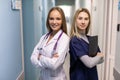 Medical Staff Talking In Hospital Corridor With Digital Tablet Royalty Free Stock Photo