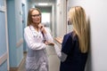 Medical Staff Talking In Hospital Corridor With Digital Tablet Royalty Free Stock Photo