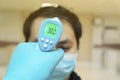 Medical staff use infrared forehead thermometer for check body temperature, Covid-19 outbreak concept Royalty Free Stock Photo