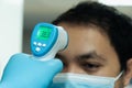 Medical staff use infrared forehead thermometer for check body temperature, Covid-19 outbreak concept Royalty Free Stock Photo