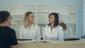 Medical staff working around busy medical reception desk Royalty Free Stock Photo