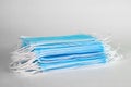 Medical sterile disposable masks. Neat stack of blue medical masks on a white background. Royalty Free Stock Photo