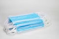 Medical sterile disposable masks. Neat stack of blue medical masks on a white background