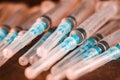 Medical Sterile Syringes Needles, Close up Syringes on wooden Background, Health care concept.