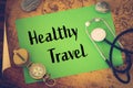 Medical stethoscope, compass and a card with the words `Healthy Travel` on the background of an old map of the world, The concept Royalty Free Stock Photo