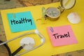 Medical stethoscope, compass and colorful cards with the words `Healthy and Travel` The concept of a safe holiday during a pandemi